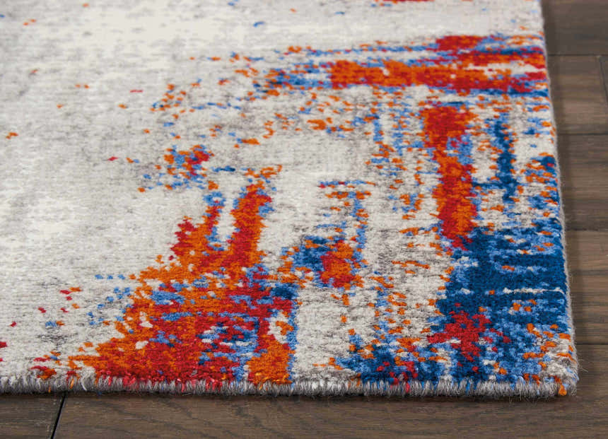 Close-up of Nourison Twilight Ivory Multicolor rug showing chestnut, blue, and ivory abstract design.