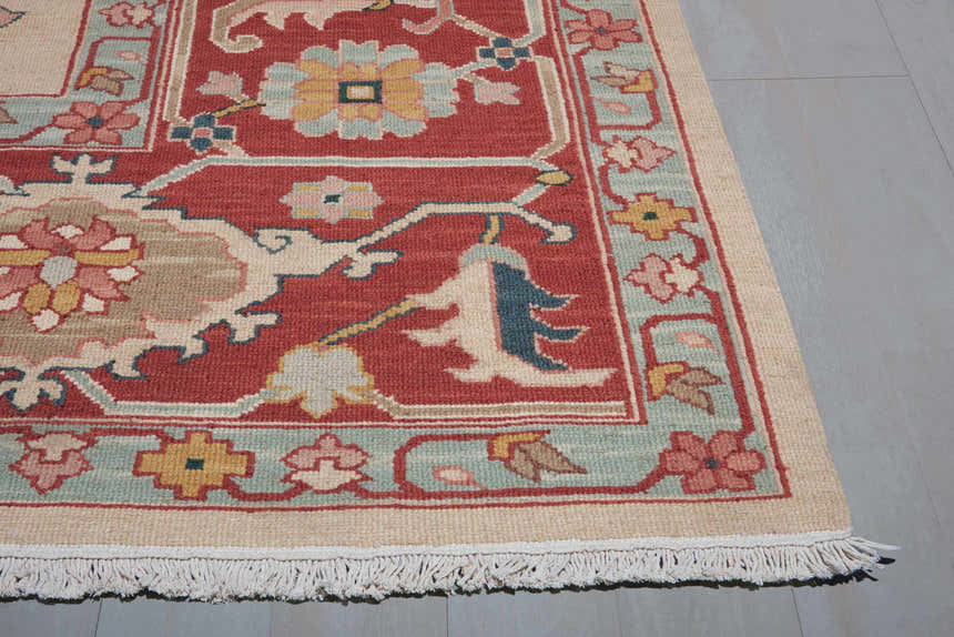 Close-up of the handmade Nourison Nourmak Light Gold Vintage Indoor Area Rug, featuring floral patterns and fringe.