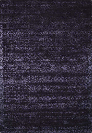 Close-up of the Calvin Klein Home Maya Nightshade rug, featuring a subtle floral pattern in deep purple and black tones.