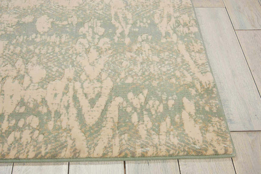 Close-up of the Nourison Nepal Seafoam Vintage Area Rug showing its sage and beige distressed pattern and soft texture.