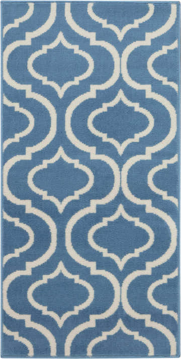 Close-up of the Nourison Jubilant Blue rug. Features a light blue background with a white quatrefoil pattern. Contemporary style.