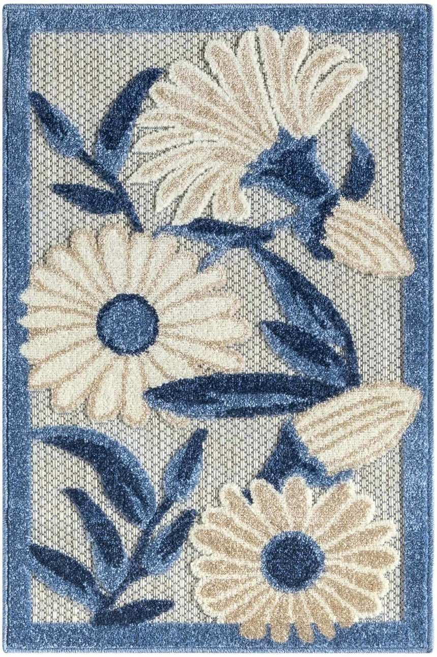 Close-up of Nourison Aloha Blue Grey outdoor rug featuring a floral design with blue leaves and tan flower petals.