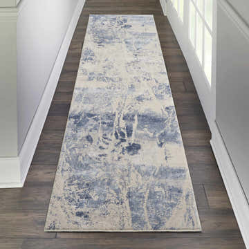 Hallway scene with Nourison Silky Textures Blue Cream rug runner on dark wood floor, white walls and door.