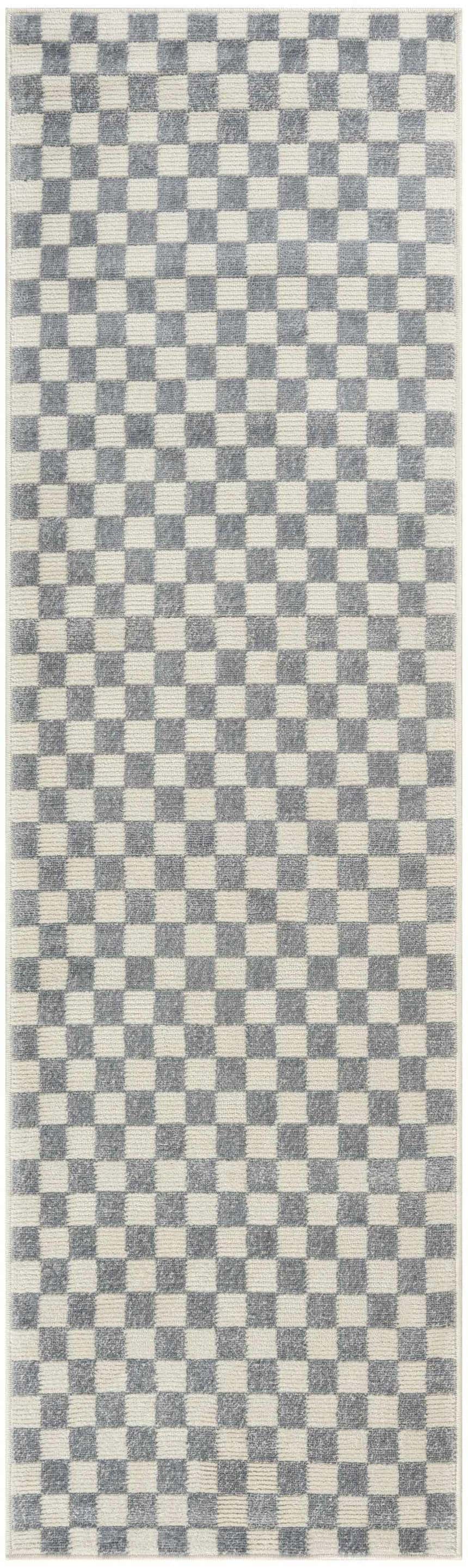 Close-up of Nourison Serenity Home Ivory Blue rug. High pile, machine-made runner with a modern checkerboard pattern.