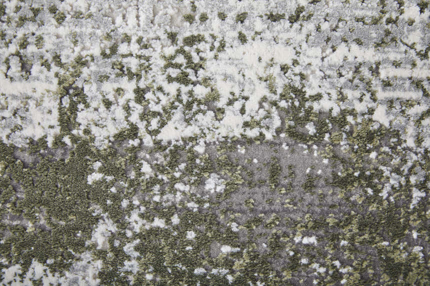 Close-up of the Feizy Cadiz rug, showcasing its gray, green, and silver ikat pattern and soft, textured pile. Texture