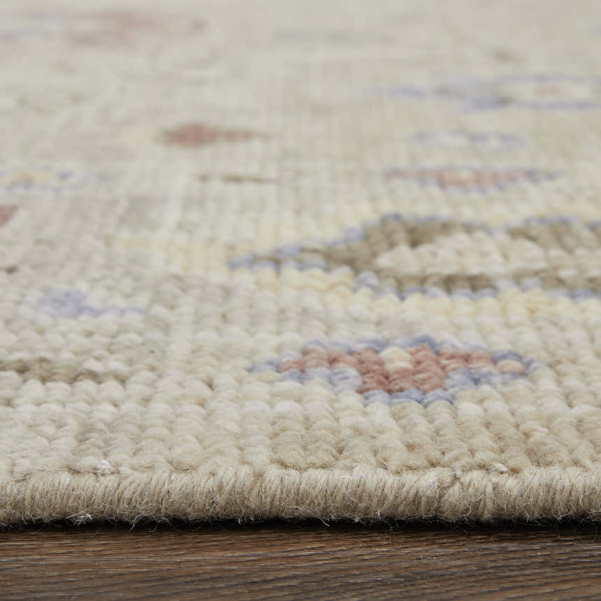 Close up of the hand knotted Feizy Fillmore rug showing wool texture and brown, tan, and blue floral pattern. Pile