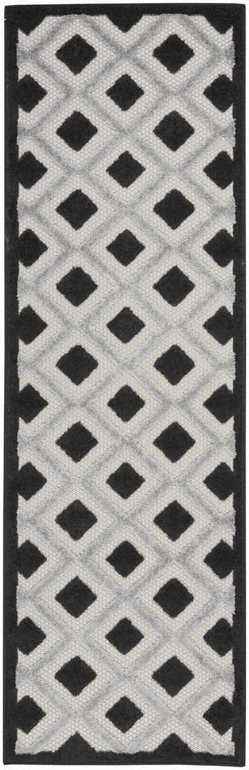 Close-up of Nourison Aloha Black White Modern Area Rug; geometric diamond pattern in black and white.