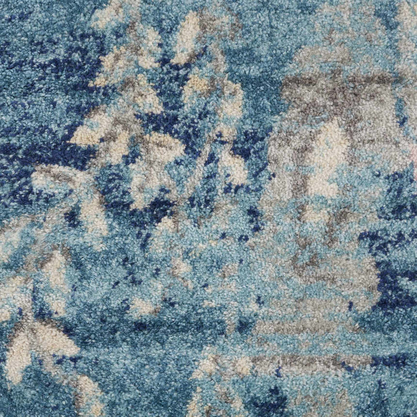 Close-up of the Nourison Tranquil Turquoise Vintage Rug. Aqua, blue, and beige abstract pattern. Soft texture.
