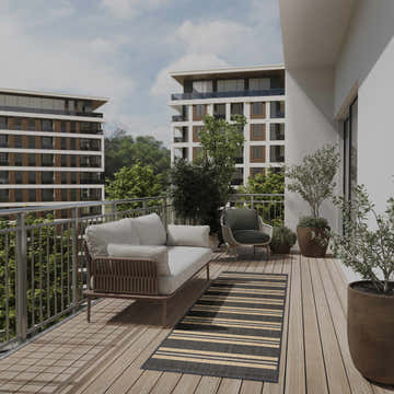 Balcony scene with a Nourison Horizon Charcoal rug, sofa, chair, and plants.