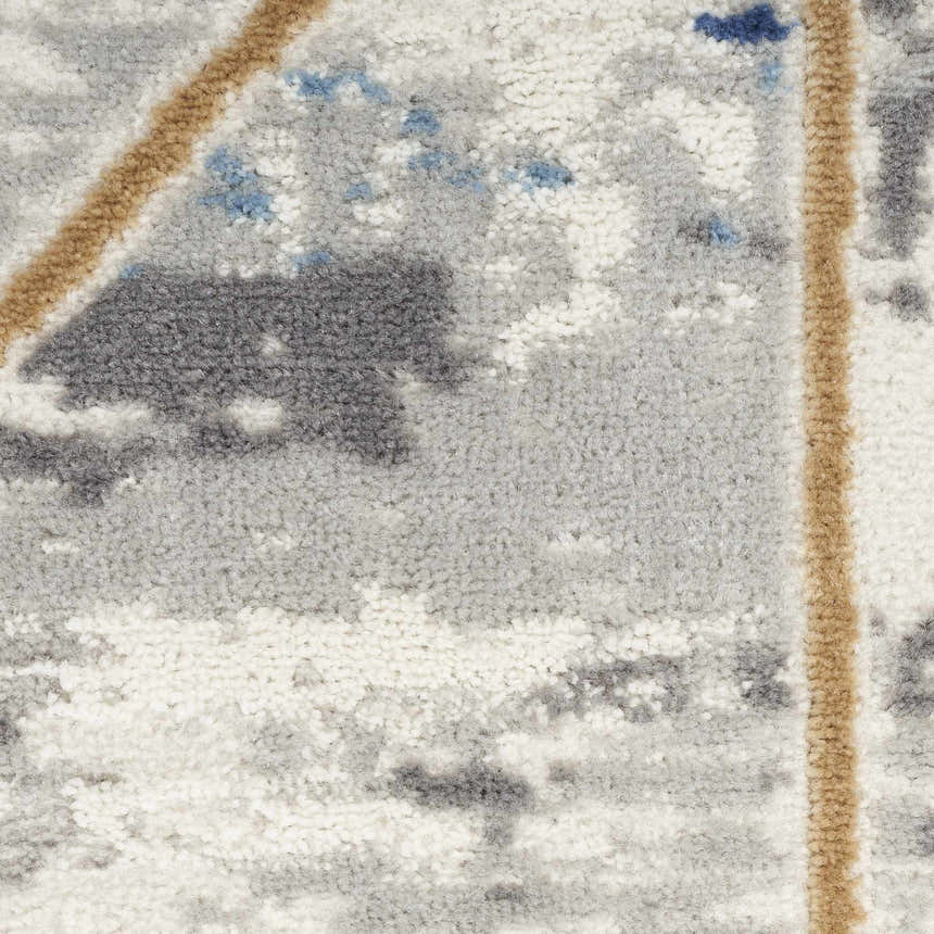 Close-up of the high pile Nourison Elation Grey Multicolor rug. Abstract pattern with gray, tan, white, and blue tones.