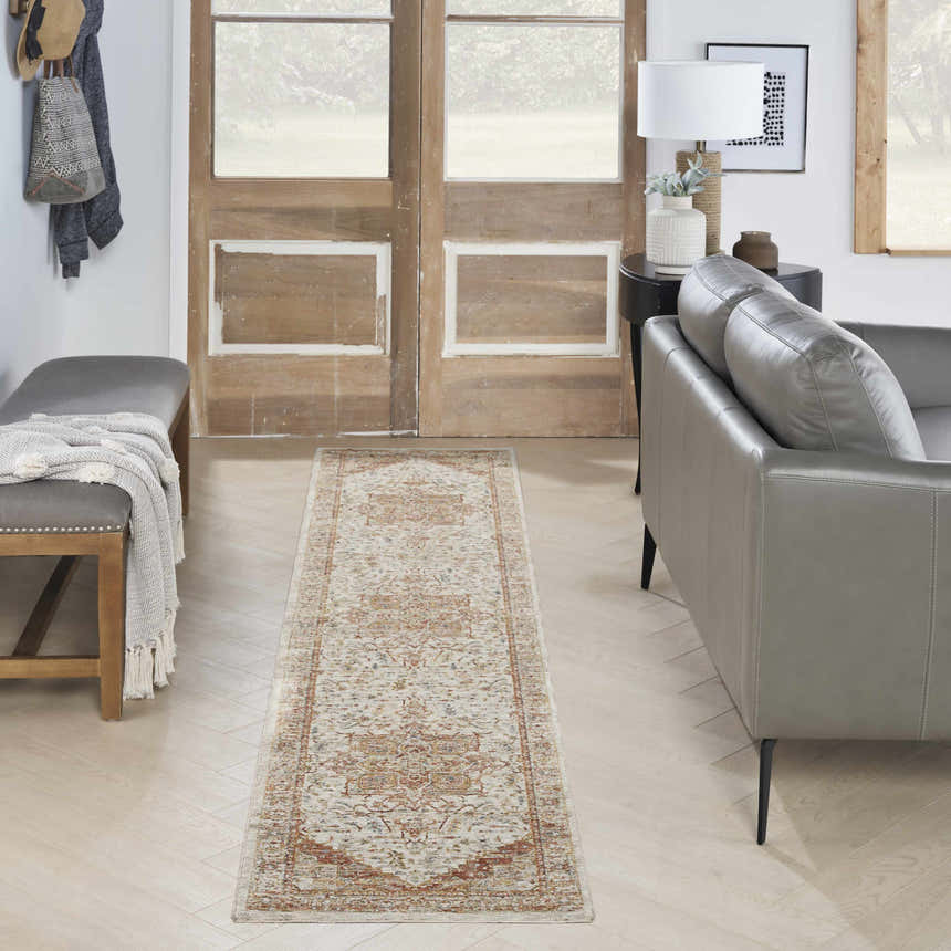 Entryway with gray bench and leather sofa featuring the Nourison Sahar Ivory Rust Vintage runner rug.