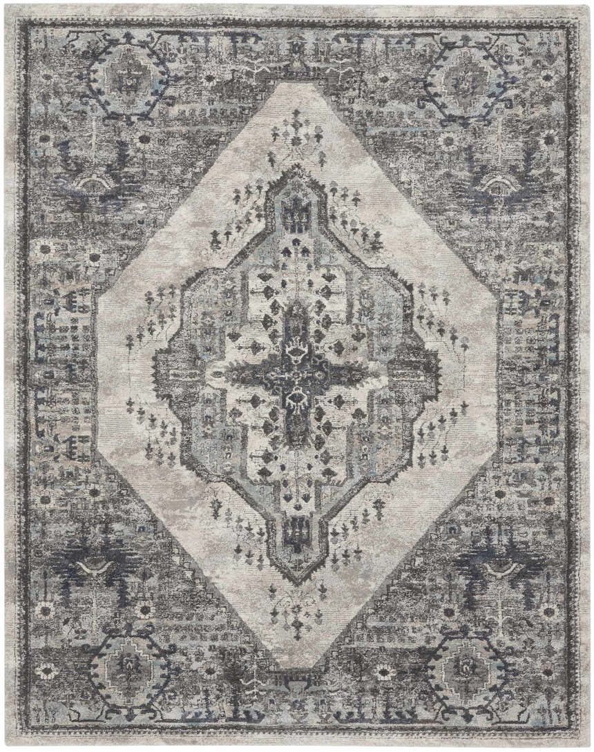 Close-up of Nourison American Manor Grey Farmhouse rug. Features a central diamond pattern and distressed traditional motifs.