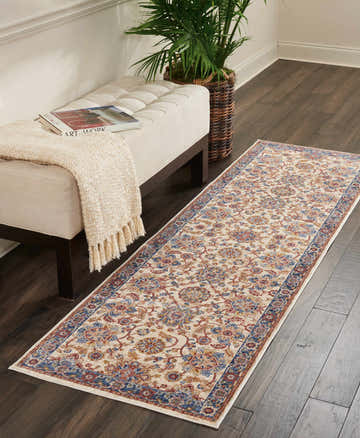 Hallway scene with a Nourison Lagos Cream Persian runner rug, bench, plant, and dark wood floors.
