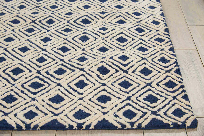 Close-up of Nourison Deco Mod Navy Ivory Rug, featuring a diamond pattern and soft, textured pile.