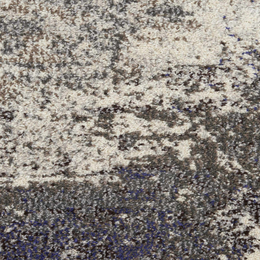 Close-up of Nourison Celestial Ivory Grey rug. Abstract pattern with ivory, grey, chestnut, and blue hues. Soft, textured pile.