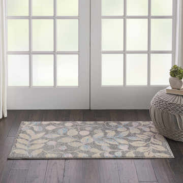 Entryway with Nourison Tranquil Grey Beige rug runner, floral pattern, wood floor, white doors, and gray pouf.