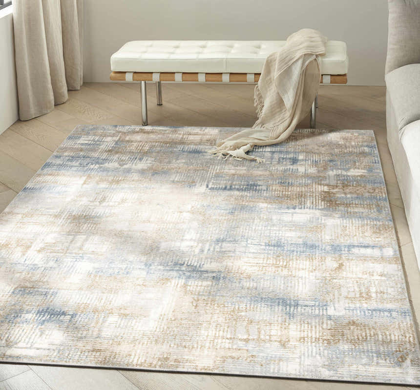 Living room scene with Calvin Klein CK950 Rush Blue Beige rug, white bench, and neutral tones for a modern, airy feel.