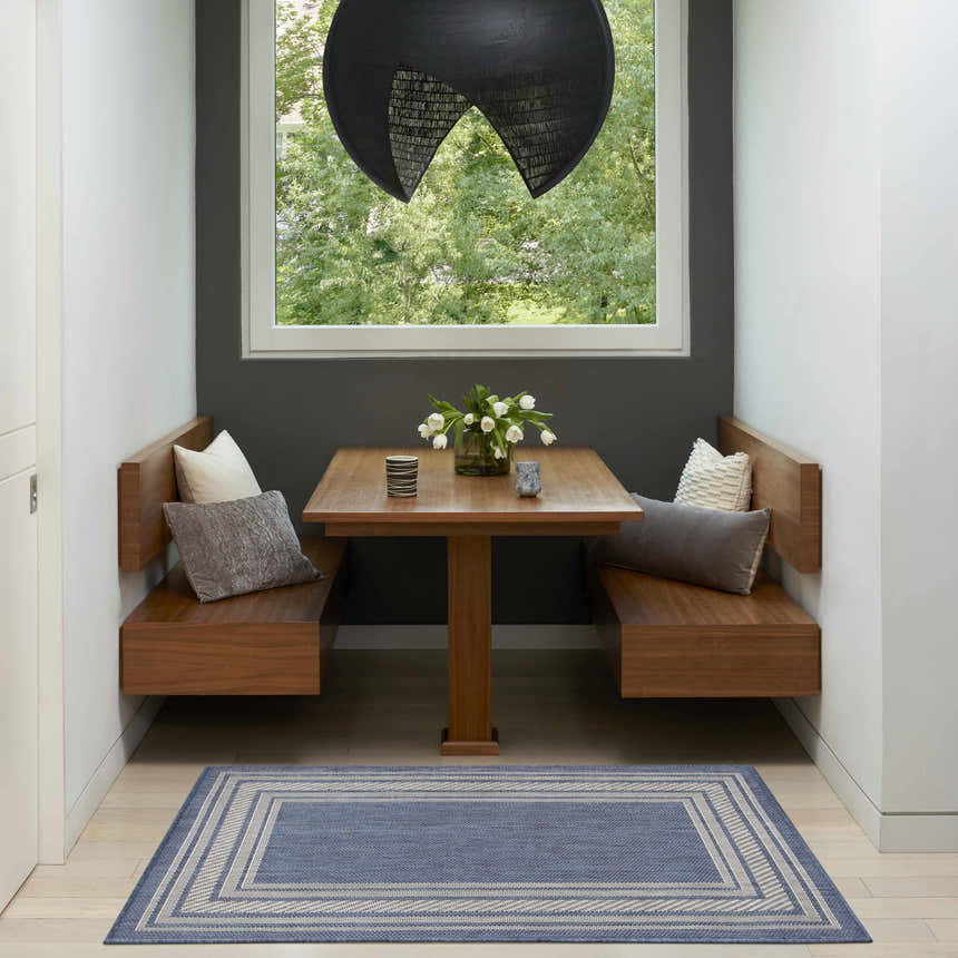 Breakfast nook with wood benches and Nourison Horizon Denim rug, bringing a modern, fresh look to the space.