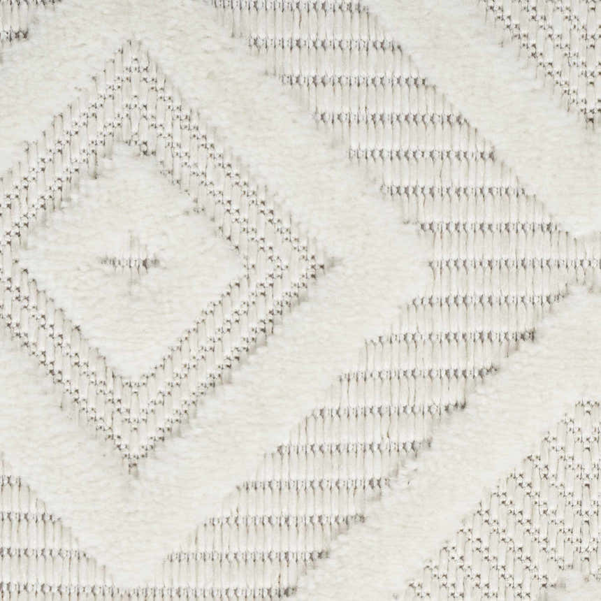 Close-up of the Nourison Versatile Ivory White rug, showing its diamond pattern and textured weave.