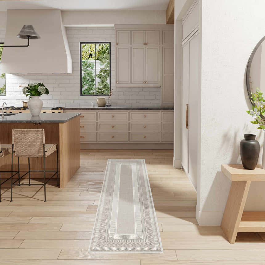 Light and airy kitchen with a Nourison Glitz Ivory runner rug, wood floors, and beige cabinets.