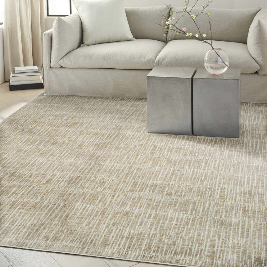 Living room scene with a Calvin Klein CK079 Notes Ivory Grey rug, neutral sofa, and concrete side tables.