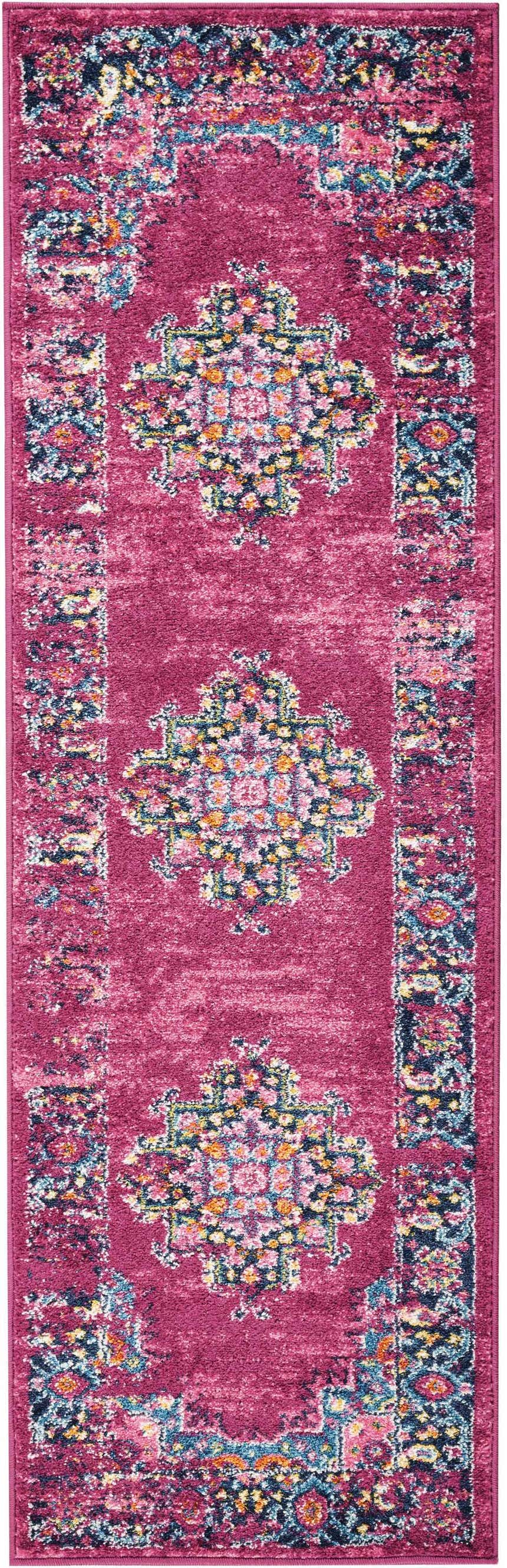 Close-up of the Nourison Passion Fuchsia rug. Features a bohemian floral pattern in fuchsia, pink, blue, and orange tones.