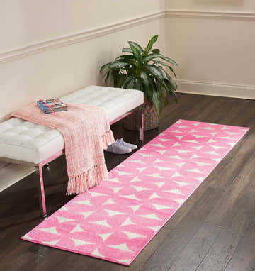 Entryway with white bench, plant, and Nourison Harper Pink Colorful runner rug on dark wood floor.