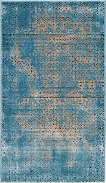Close-up of Nourison Karma Blue Vintage rug. Light blue and beige distressed pattern. Machine-made polypropylene jute rug.