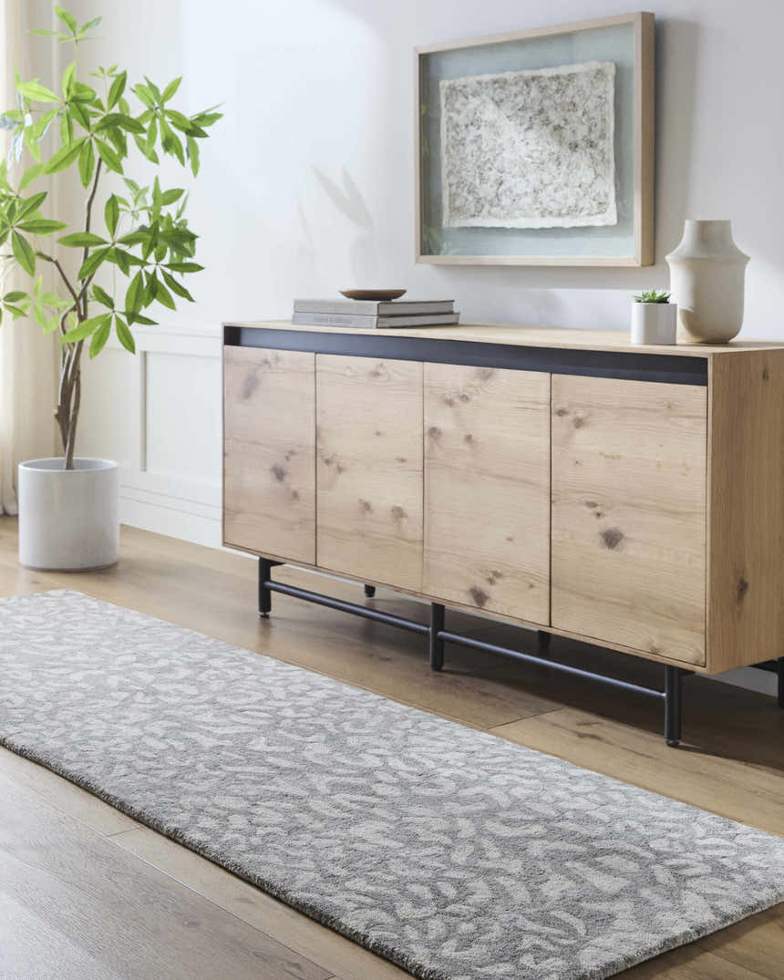 Entryway with a beige Circa Leopard Print Area Rug runner, wood floors, and a modern console table. Roomscene-Runner
