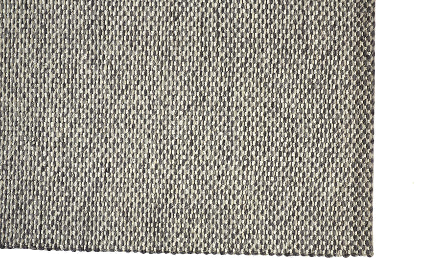Close-up of the hand woven Feizy Berkeley rug. Gray and ivory wool creates a textured, transitional design. Corner