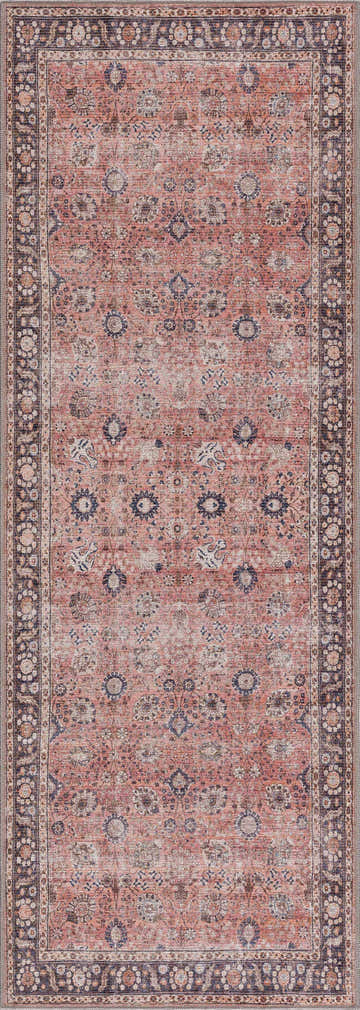 Close-up of the Ganyangan Red Washable Rug, featuring a traditional floral pattern in brick red, blue, and beige tones. Design-Runner-2773