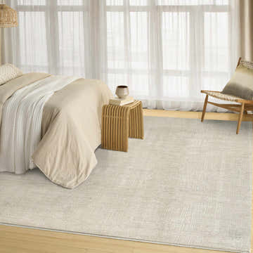 Serene bedroom with DKNY DK014 Madison Ivory Beige rug, light wood floors, sheer curtains, and neutral tones.