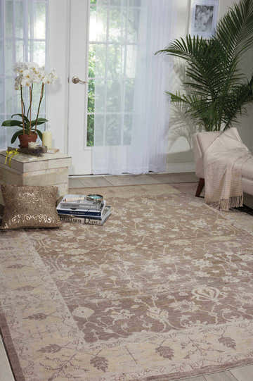 Sunlit room with a Nourison Aldora Sand Vintage Area Rug, sandstone tones, floral pattern, and a relaxed feel.