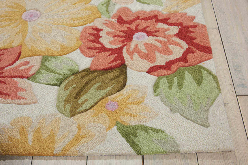 Close-up of the Nourison Fantasy Cream rug, featuring a floral pattern with yellow, red, and green hues. Handmade texture.