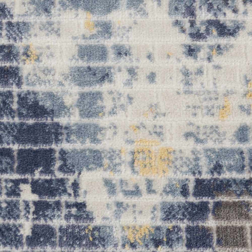Close-up of Nourison Urban Decor Ivory/Sky rug. Modern design with blue, ivory, and yellow brick-like pattern. Soft texture.