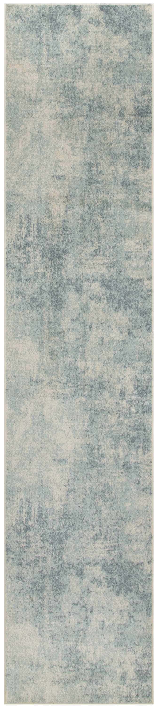 Close-up of the Nourison Astra rug in blue and ivory. Abstract, distressed pattern. Machine-made texture.