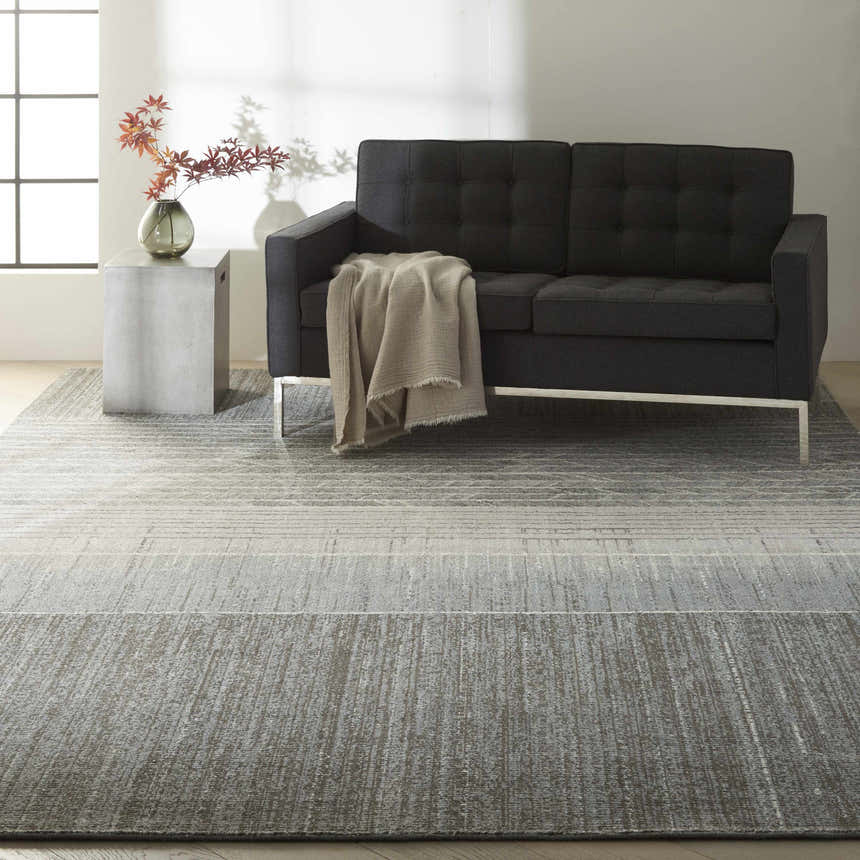 Living room scene with a Basalt Calvin Klein Home Gradient rug, gray sofa, and modern decor.