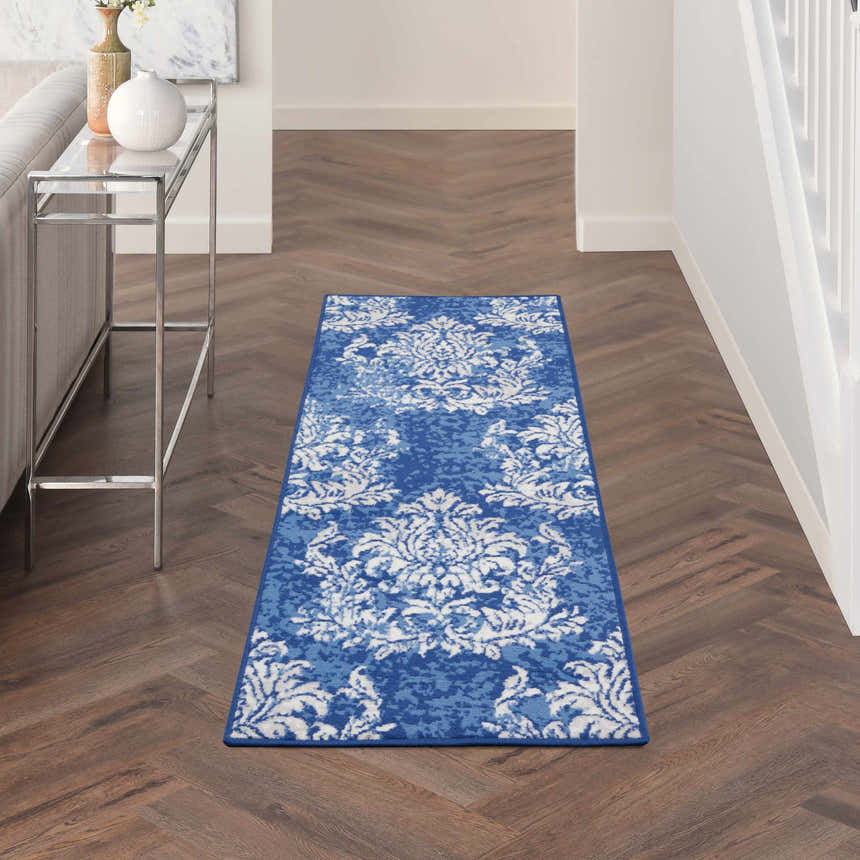 Hallway with Nourison Whimsicle Navy Ivory rug runner on herringbone wood floor. Farmhouse style.