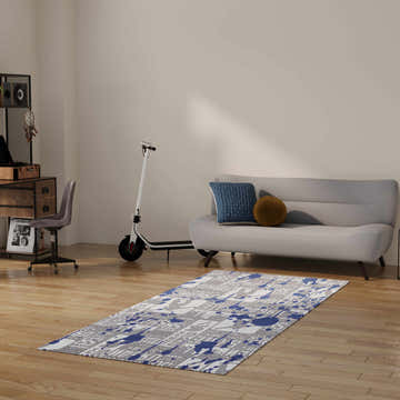 Kids room scene with a Nourison Imagination Blue Washable Area Rug, gray sofa, and scooter.