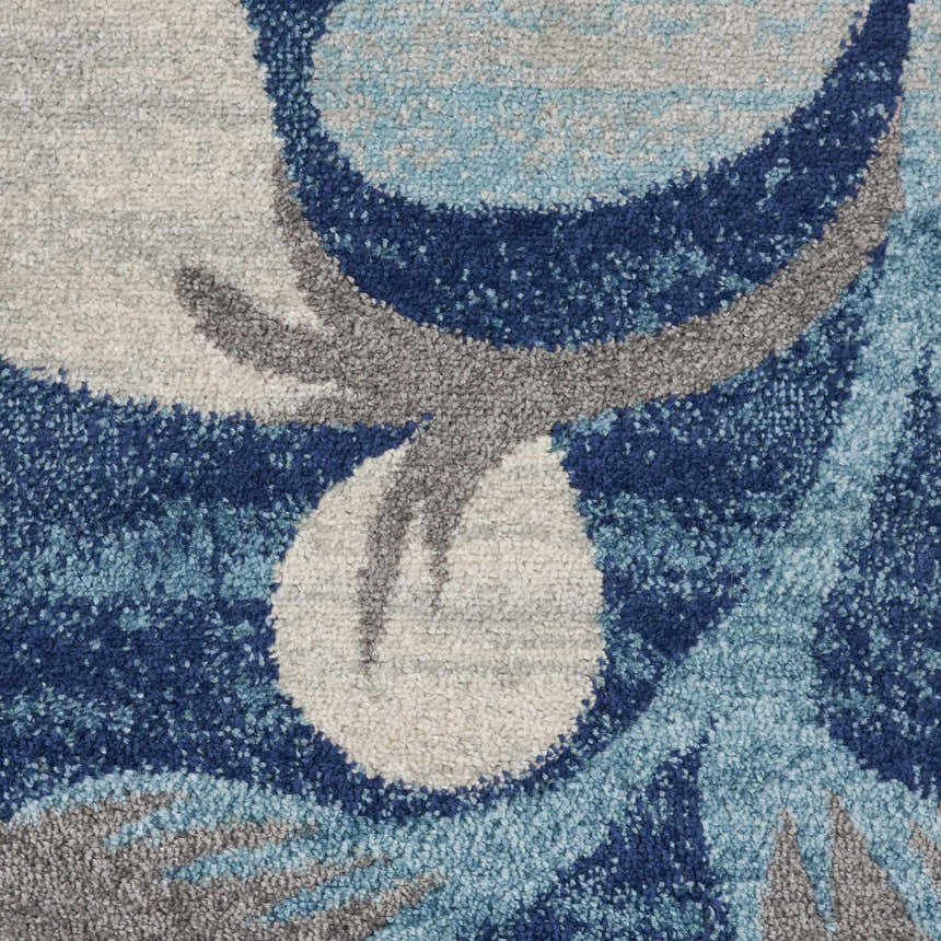 Close-up of the Nourison Tranquil Navy rug, showing a textured pattern in navy, gray, and light blue hues.