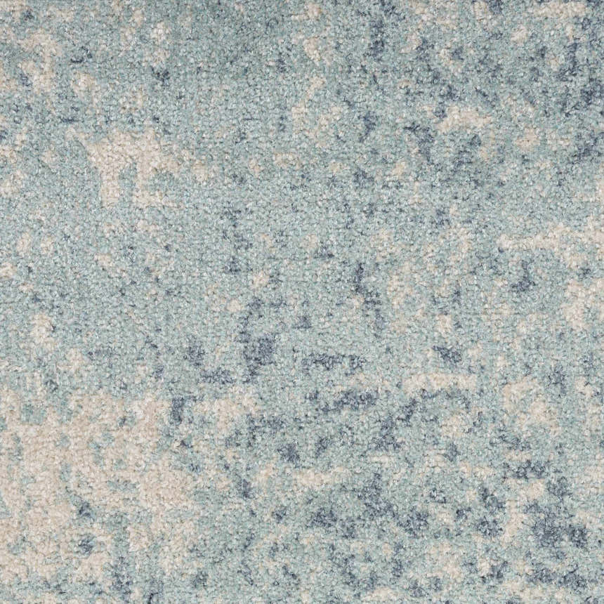 Close-up of the Nourison Astra Rug in blue and ivory. Abstract pattern with a soft, textured pile.