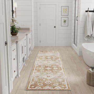 White bathroom with a Nourison Astra Copper Vintage rug runner on wood floor.
