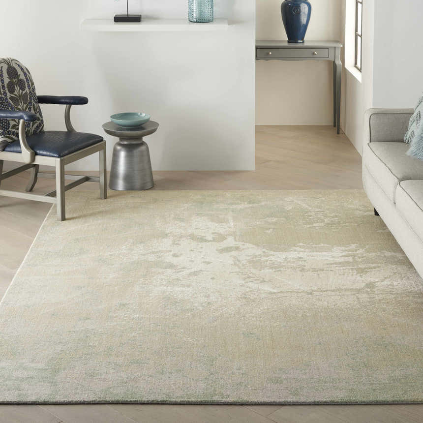 Living room scene with a Nourison Twilight Ivory Green rug, light gray sofa, and modern decor.