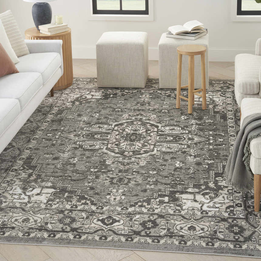 Living room scene with a Nourison Quarry Grey Vintage Indoor Area Rug, white sofas, and neutral-toned accents.