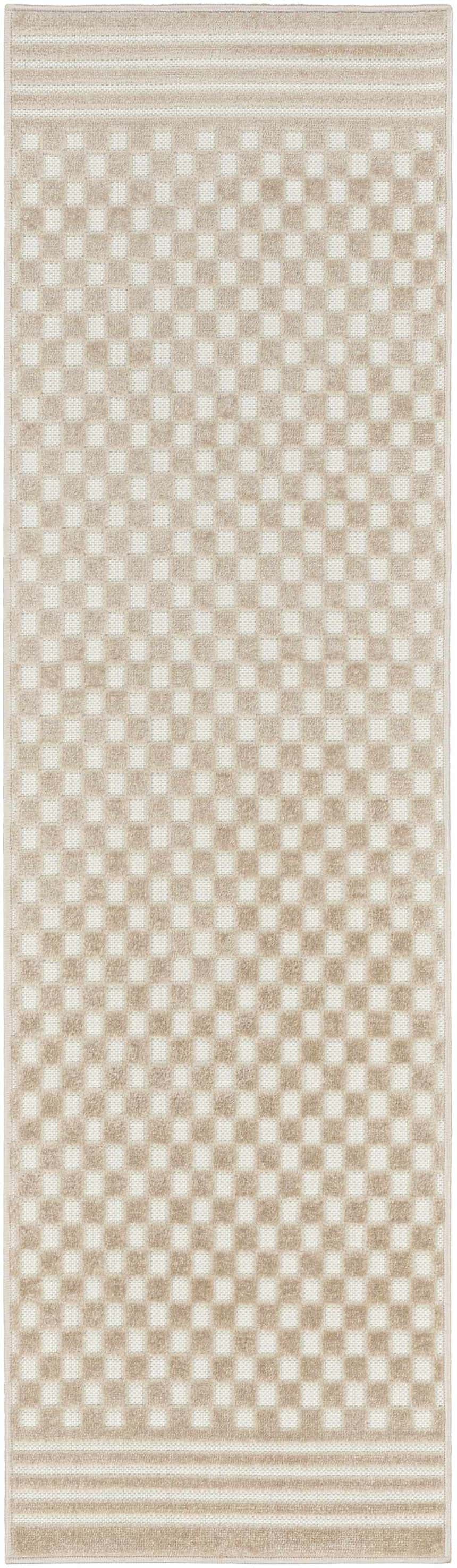 Close-up of the Nourison Care Free Beige rug. Features a checkerboard pattern and striped borders. Modern style.