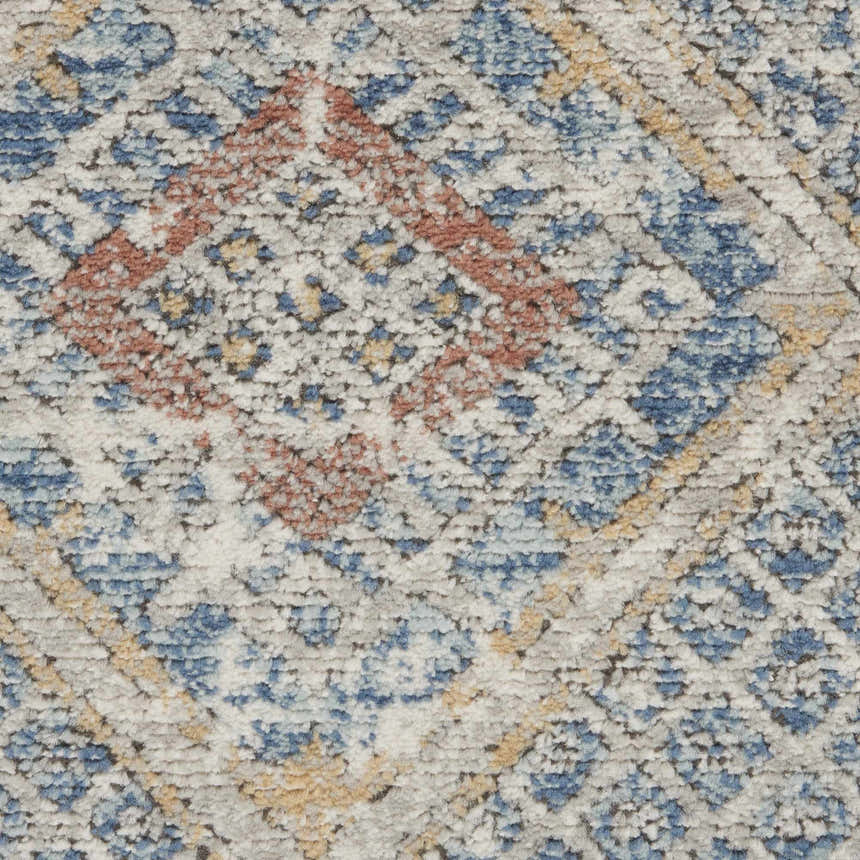 Close-up of Nourison Quarry Blue Ivory Southwestern Rug. Chestnut, blue, and ivory diamond pattern. Soft, textured pile.