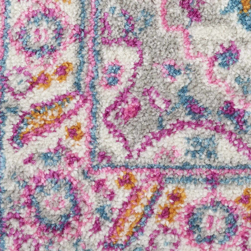 Close-up of Nourison Passion Light Grey Pink rug, showing its bohemian pattern, pink, blue, gold, and gray colors.