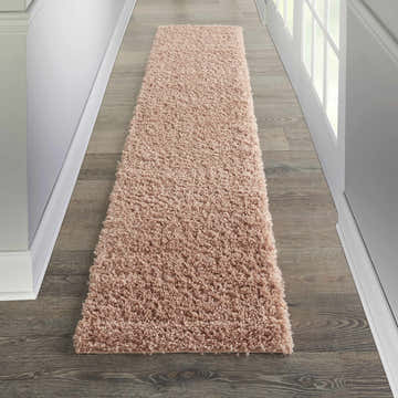 Hallway with a Nourison Malibu Shag Blush runner rug on wood floor.
