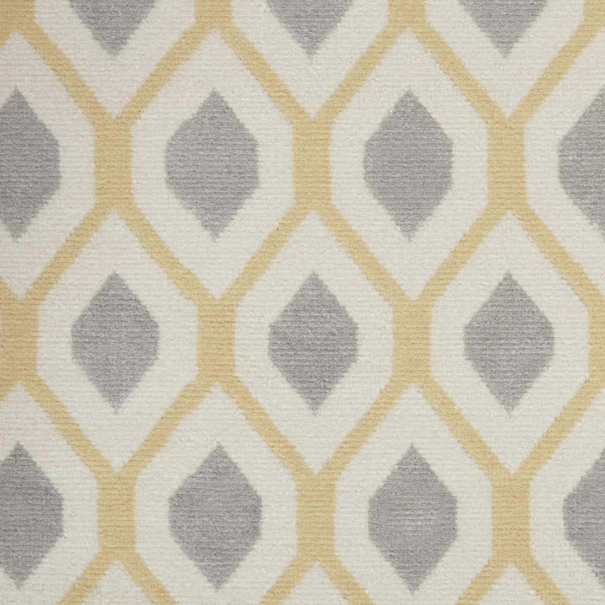 Close up of the Nourison Grafix White rug featuring a geometric diamond pattern in off-white, gray, and light yellow.