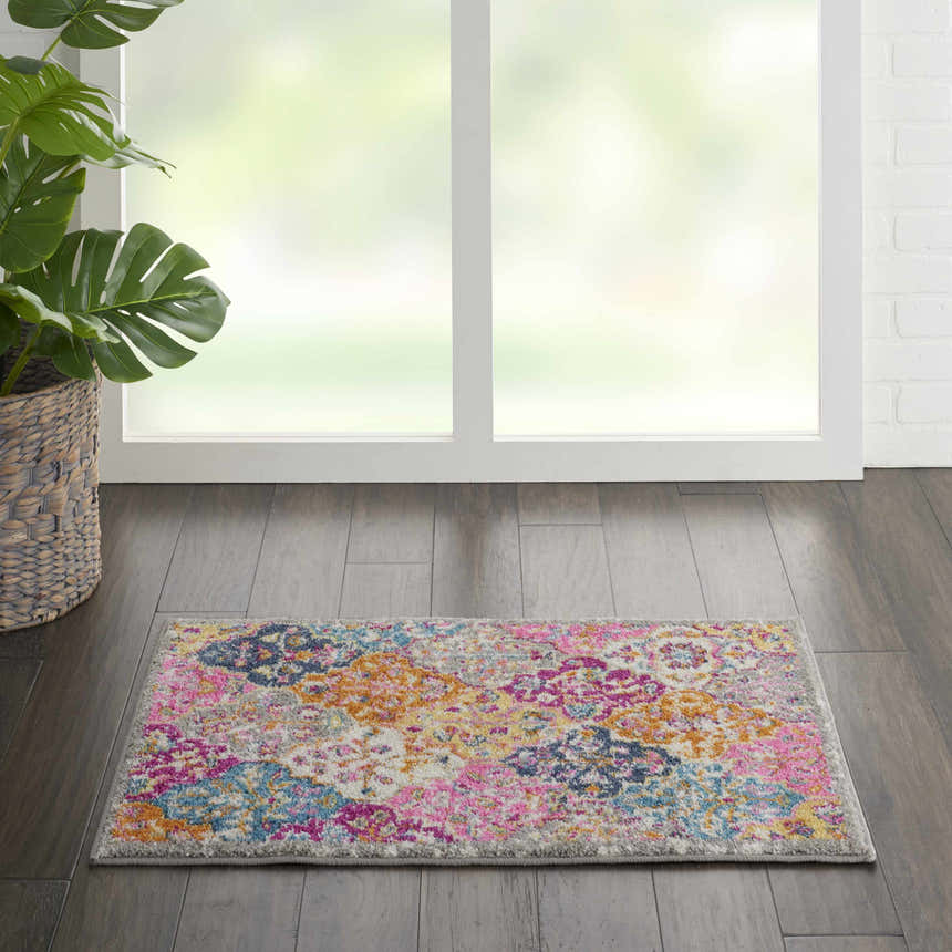 Bright Nourison Passion Multicolor Bohemian rug on dark wood floor near a window and potted plant.